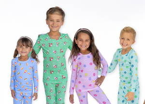Four children wearing colorful pajamas on a white background