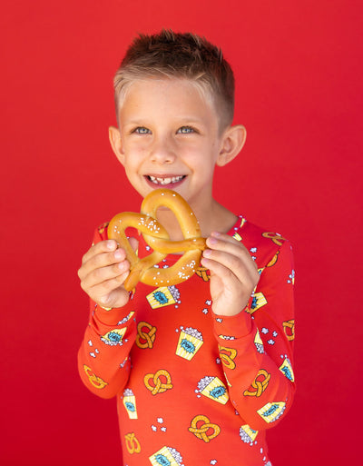 Boy in PJs with pretzel