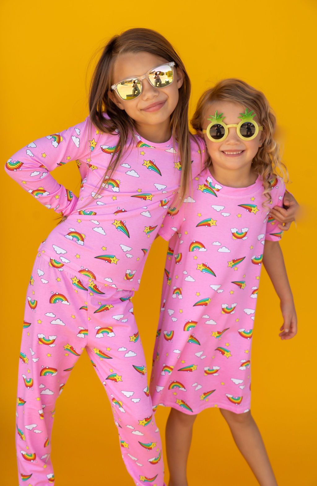 Two girls in matching Pink PJs and Lounge dress